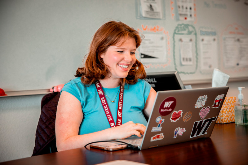 WT Student Smiling at Computer 